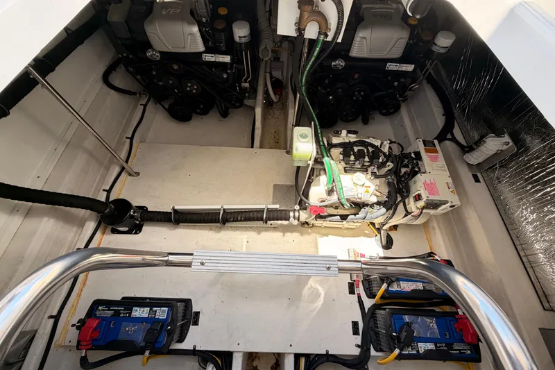 Slide: The Image of Engine compartment of 2020 Cruisers Yachts 390 Express Coupe, showcasing dual engines and batteries. - 79