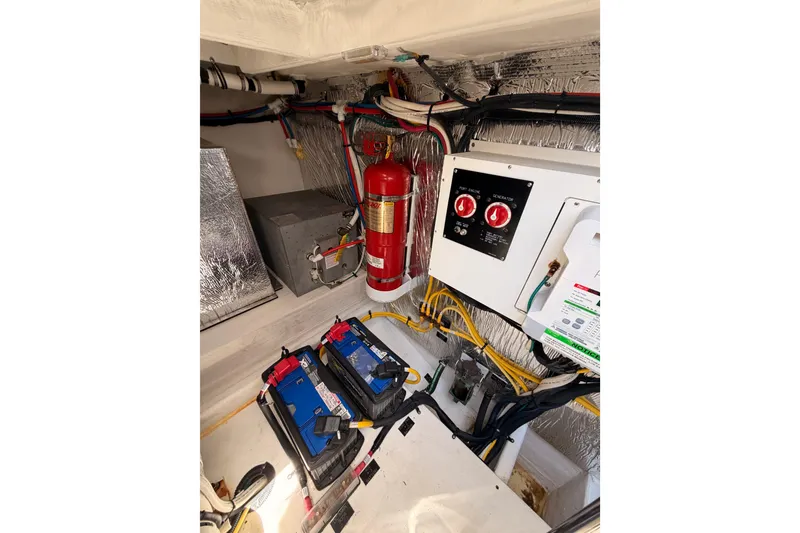 Slide: The Image of Engine room of 2020 Cruisers Yachts 390 Express Coupe with batteries and fire extinguisher. - 80