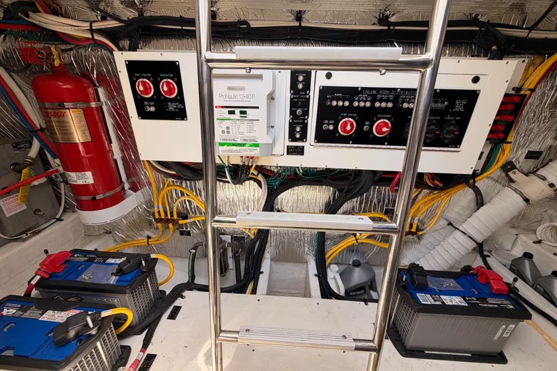 Slide: The Image of Engine room of 2020 Cruisers Yachts 390 Express Coupe with control panels and batteries. - 81