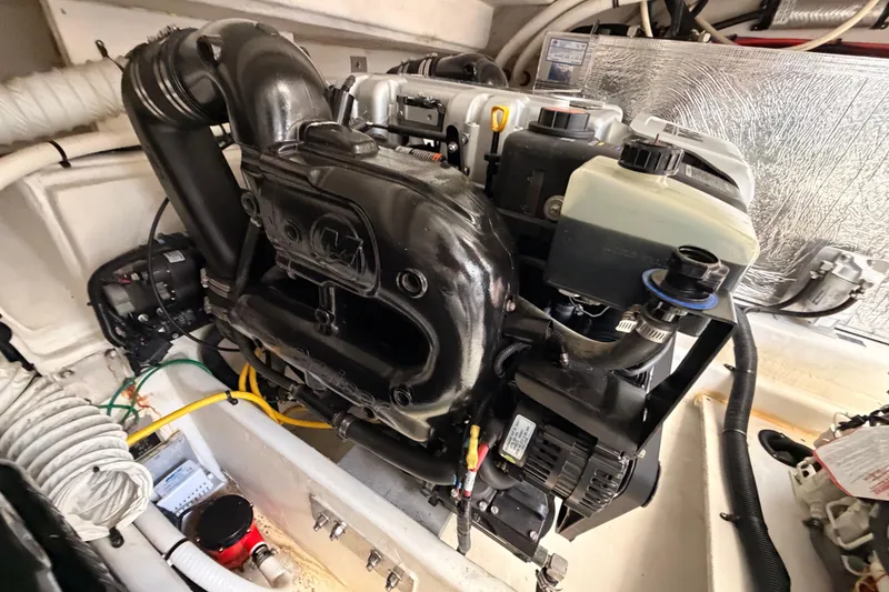Slide: The Image of Engine compartment of 2020 Cruisers Yachts 390 Express Coupe, showcasing detailed mechanical components. - 87