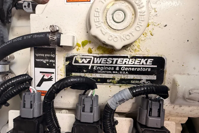 Slide: The Image of Westerbeke engine detail on 2020 Cruisers Yachts 390 Express Coupe, showing connectors and labels. - 91