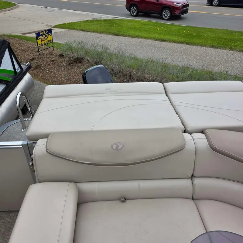 Slide: The Image of 2017 Tahoe CASCADE boat with beige upholstered seating on parking lot. - 7