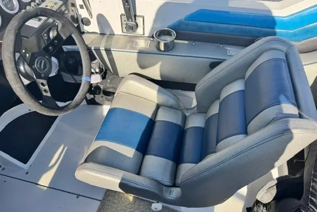 The Image of 1984 Wellcraft 22 Scarab cockpit with striped seat and steering wheel. - 1
