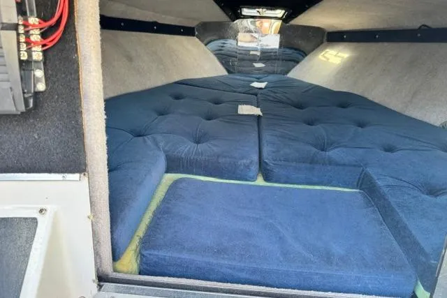 Slide: The Image of Interior cabin of 1984 Wellcraft 22 Scarab boat with blue cushioned seating. - 6