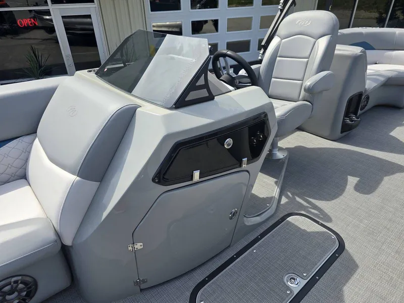 Slide: The Image of Interior of 2022 Manitou 23 Encore RF SHP with helm console. - 11