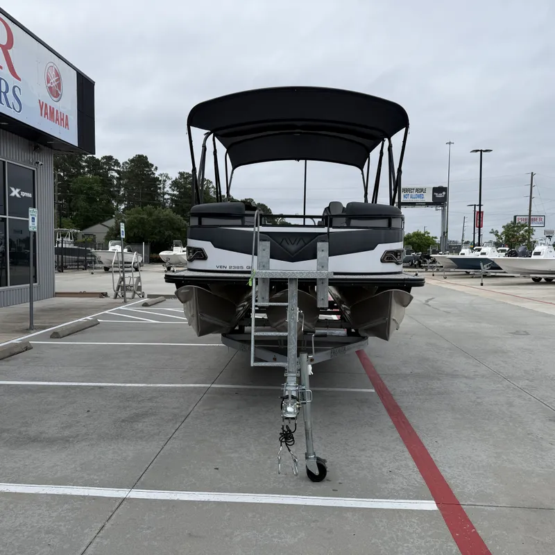 Slide: The Image of 2025 Avalon Venture 85 Quad Lounge boat on trailer outdoors. - 5