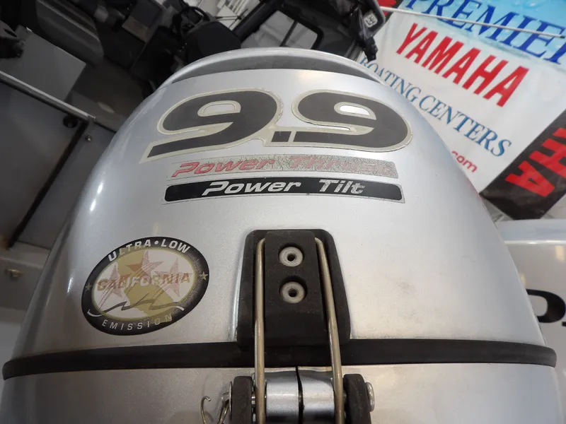 Slide: The Image of Outboard motor with 9.9 HP and Power Tilt, Ultra-Low Emission. - 9