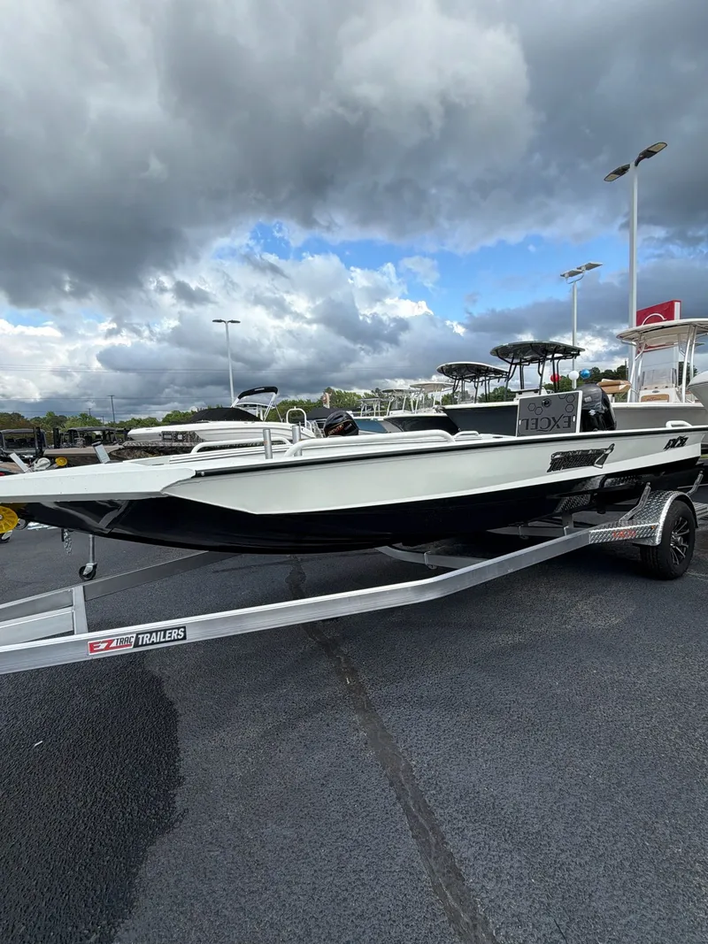 Slide: The Image of 2026 Excel 183 Tomahawk boat on trailer under cloudy sky. - 4