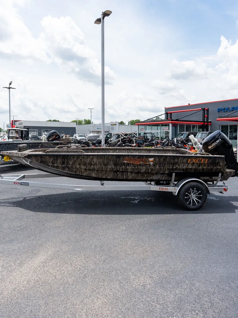 Slide: The Image of Excel 183 Tomahawk boat 2026 on trailer outside dealership. - 3