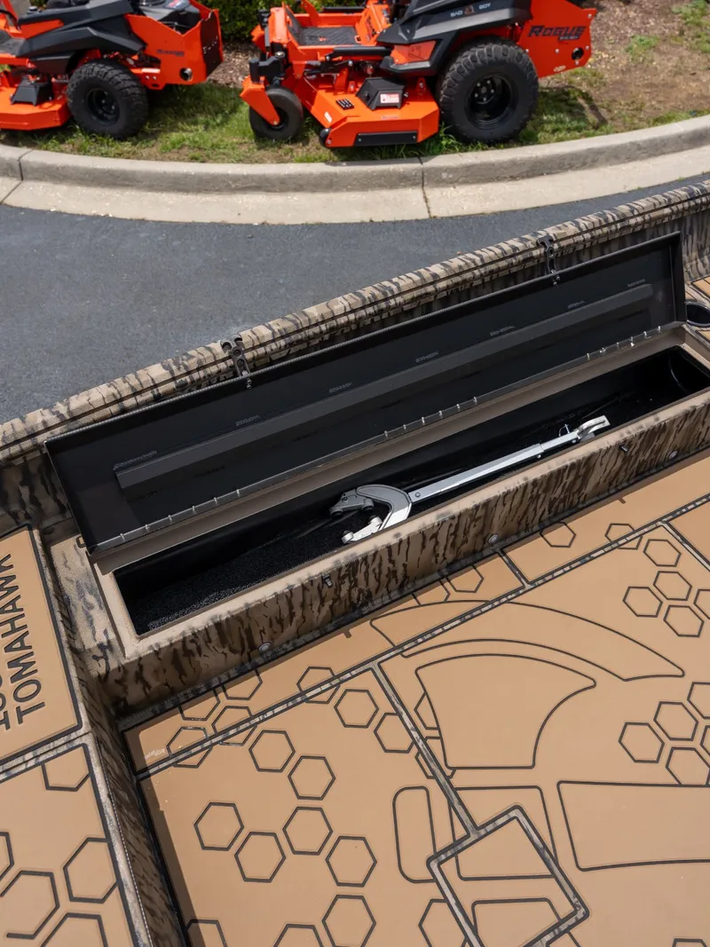 Slide: The Image of Excel 183 Tomahawk 2026 with tool compartment and lawn mowers in background. - 8