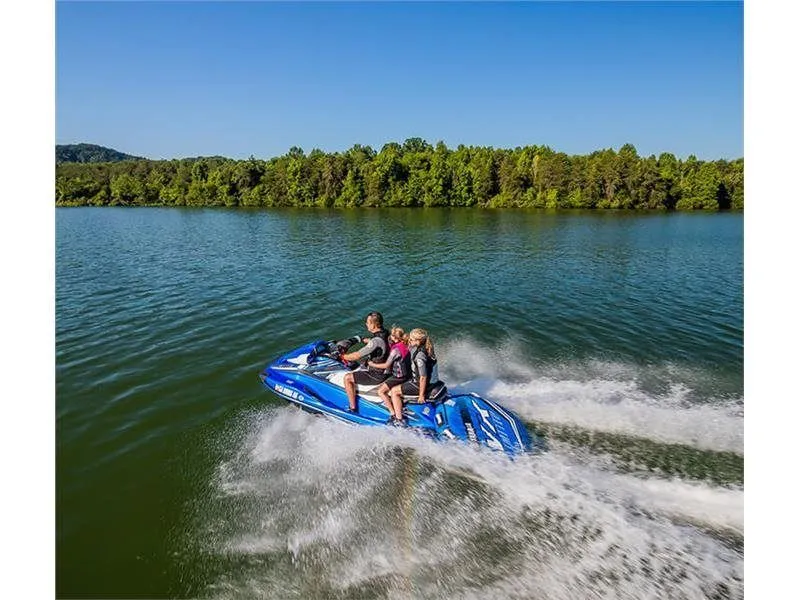 Slide: The Image of 2017 Yamaha VX Limited jet ski on a lake with three riders. - 4