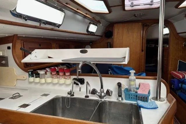 Slide: The Image of Interior of a 1996 Freedom 35 sailboat kitchen with sink and spice rack. - 12