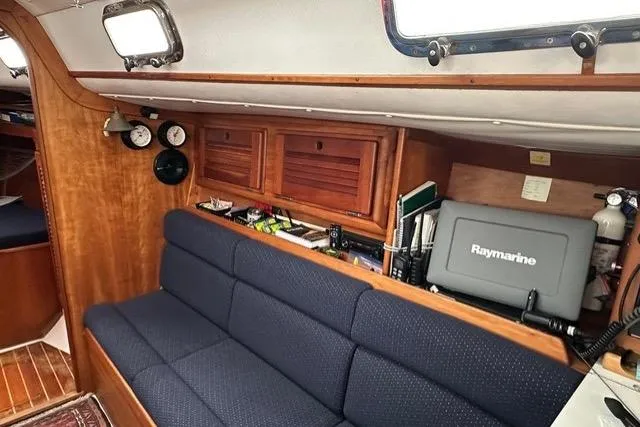 Slide: The Image of Interior of 1996 Freedom 35 sailboat with blue seating and navigation equipment. - 2