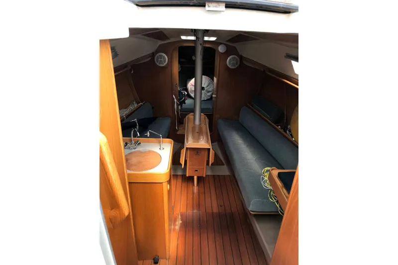Slide: The Image of Interior of 1988 Beneteau First 285 sailboat with wooden finish and blue seating. - 6