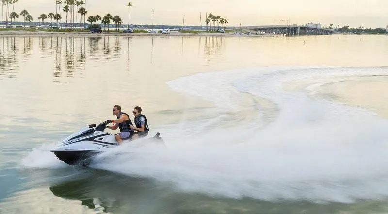 Slide: The Image of Two people riding 2020 Yamaha VX Limited jet ski on calm water. - 3