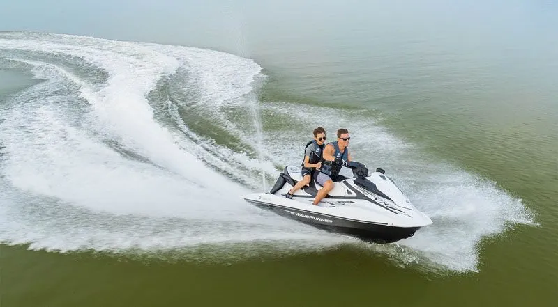 Slide: The Image of Two people riding 2020 Yamaha VX Limited jet ski on water. - 5