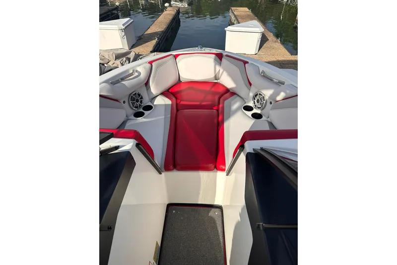 Slide: The Image of 2017 Axis T23 boat interior with red and white seating, cup holders, and speakers. - 4
