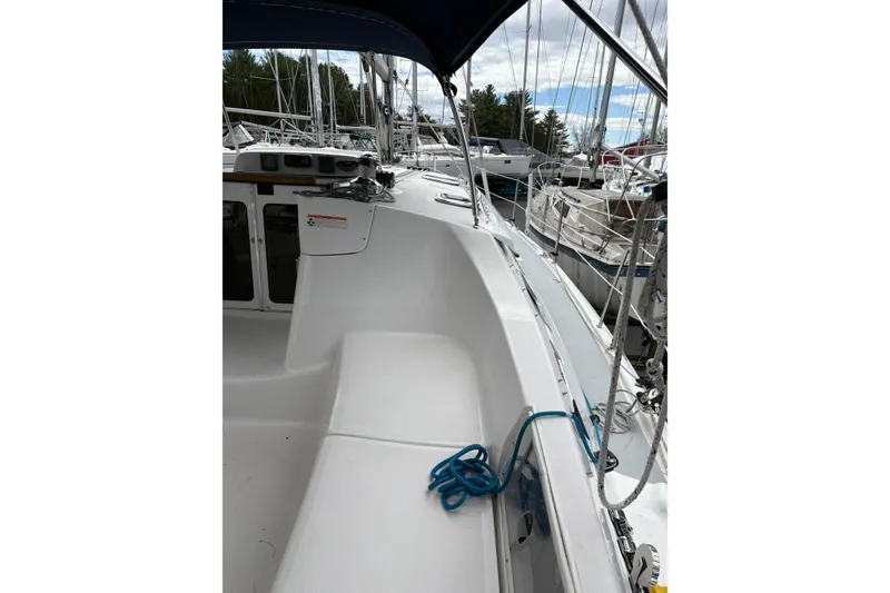 Slide: The Image of 2009 Hunter 41 Deck Salon sailboat deck with blue rope and marina view. - 10