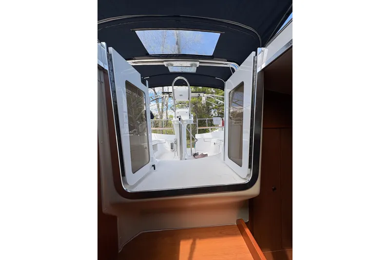 Slide: The Image of 2009 Hunter 41 Deck Salon interior view with open doors and cockpit. - 100