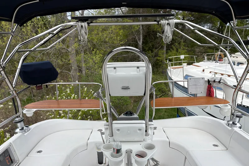 Slide: The Image of Cockpit view of 2009 Hunter 41 Deck Salon sailboat with polished metal and wood accents. - 12