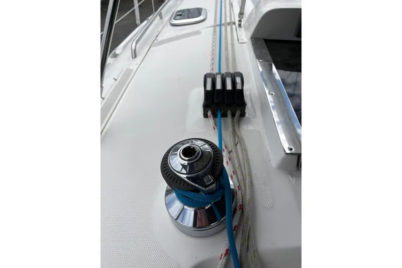 Slide: The Image of 2009 Hunter 41 Deck Salon sailboat deck with winch and ropes. - 16