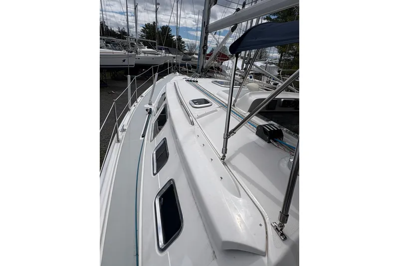 Slide: The Image of 2009 Hunter 41 Deck Salon sailboat with sleek white deck and multiple windows. - 23