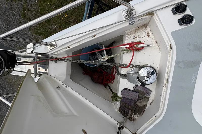 Slide: The Image of Anchor locker of 2009 Hunter 41 Deck Salon with ropes and gloves. - 25