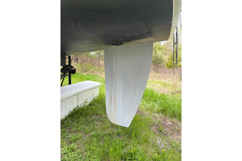 Slide: The Image of 2009 Hunter 41 Deck Salon keel and propeller on grassy terrain. - 3