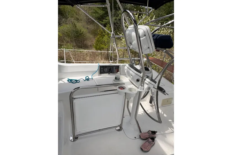 Slide: The Image of Cockpit of 2009 Hunter 41 Deck Salon sailboat with steering wheel and navigation equipment. - 33