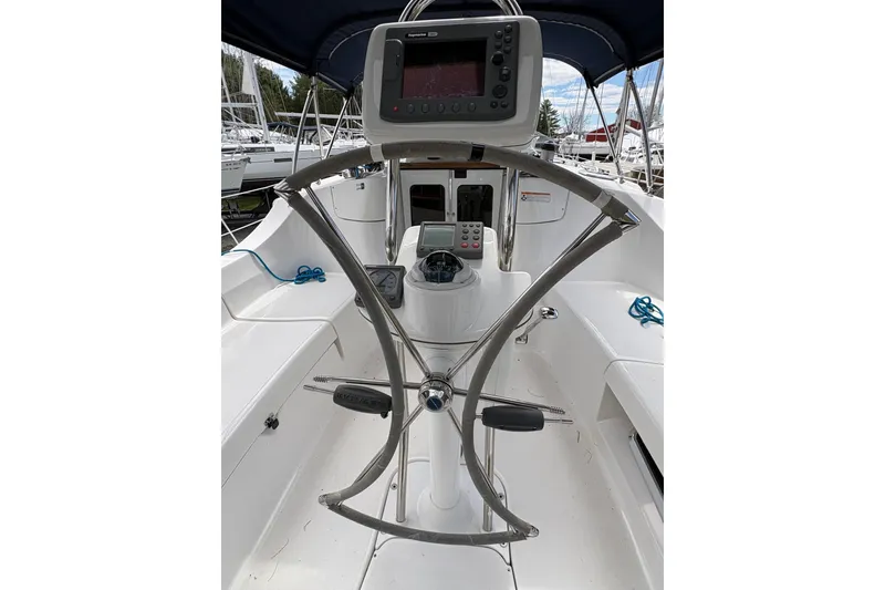 Slide: The Image of 2009 Hunter 41 Deck Salon cockpit with steering wheel and navigation equipment. - 37