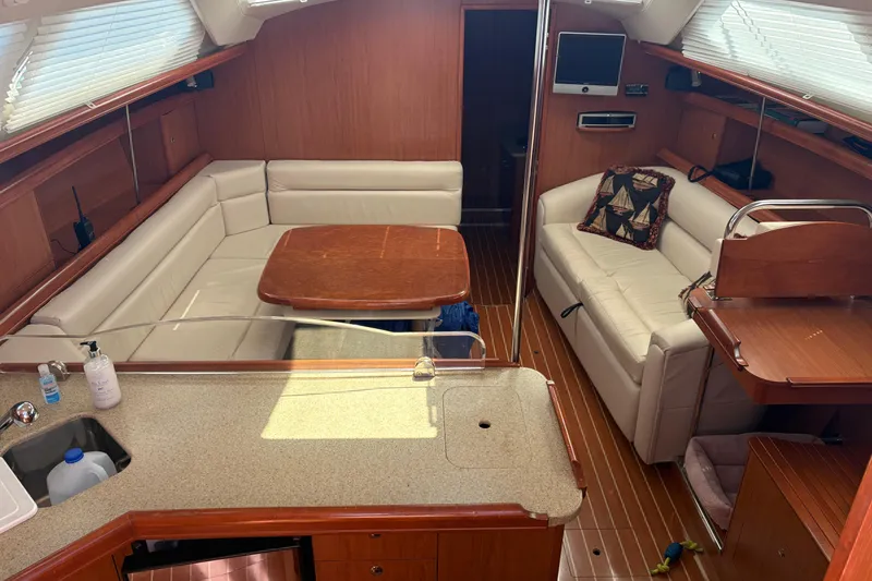 Slide: The Image of 2009 Hunter 41 Deck Salon interior with elegant seating and wooden finishes. - 39