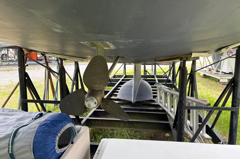 Slide: The Image of Underneath view of a 2009 Hunter 41 Deck Salon sailboat on a stand, showing the propeller. - 4