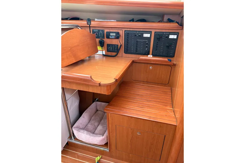 Slide: The Image of 2009 Hunter 41 Deck Salon interior with wooden cabinetry and control panels. - 43