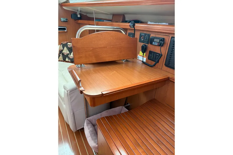Slide: The Image of Interior of 2009 Hunter 41 Deck Salon with wooden desk and navigation equipment. - 44