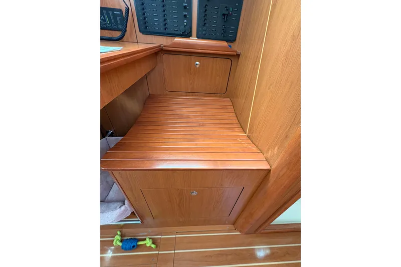 Slide: The Image of 2009 Hunter 41 Deck Salon interior with wooden cabinetry and control panel. - 45