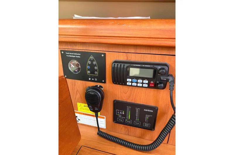 Slide: The Image of Control panel of 2009 Hunter 41 Deck Salon with VHF radio and tank-level indicators. - 47