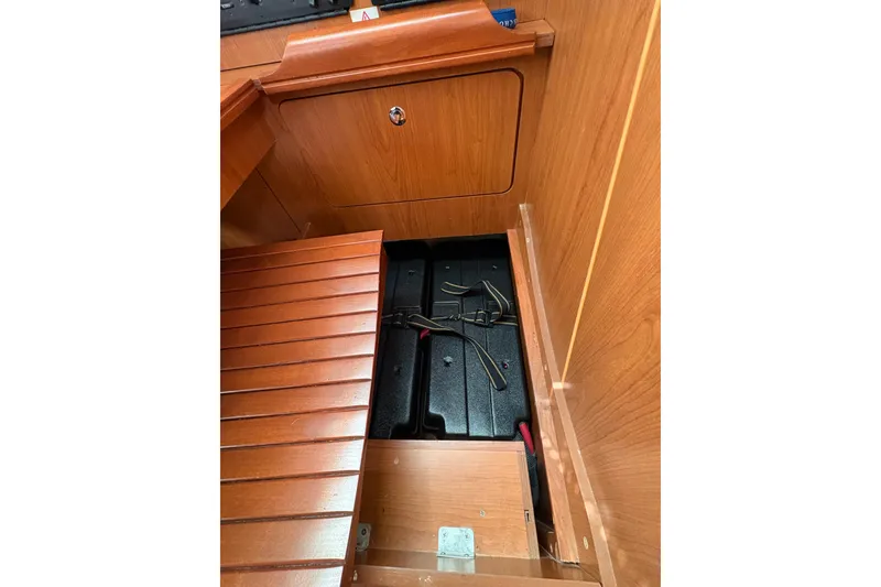 Slide: The Image of Interior view of 2009 Hunter 41 Deck Salon showing wooden cabinetry and storage compartment. - 51