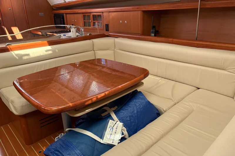 Slide: The Image of Luxurious interior of 2009 Hunter 41 Deck Salon with elegant wood table and beige seating. - 55