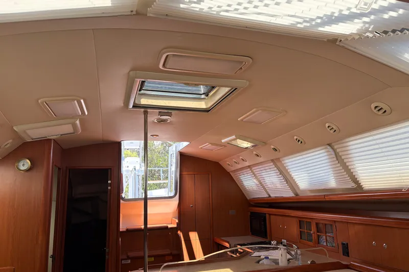 Slide: The Image of Interior of 2009 Hunter 41 Deck Salon with skylights and wooden cabinetry. - 56