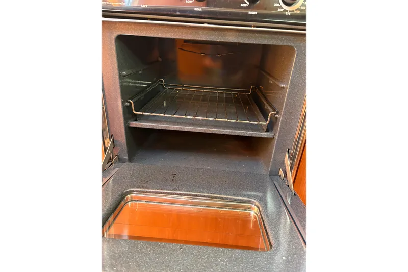 Slide: The Image of Open oven inside a 2009 Hunter 41 Deck Salon yacht kitchen. - 61