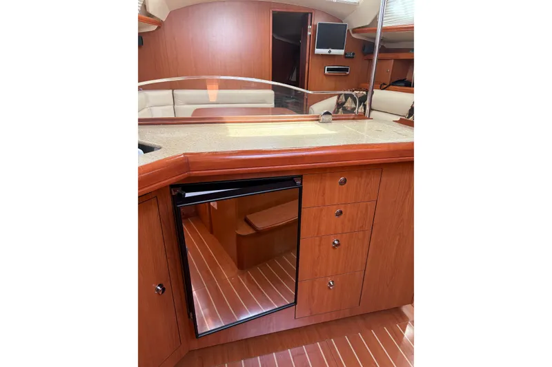 Slide: The Image of Interior of 2009 Hunter 41 Deck Salon yacht with wooden cabinetry and modern amenities. - 62