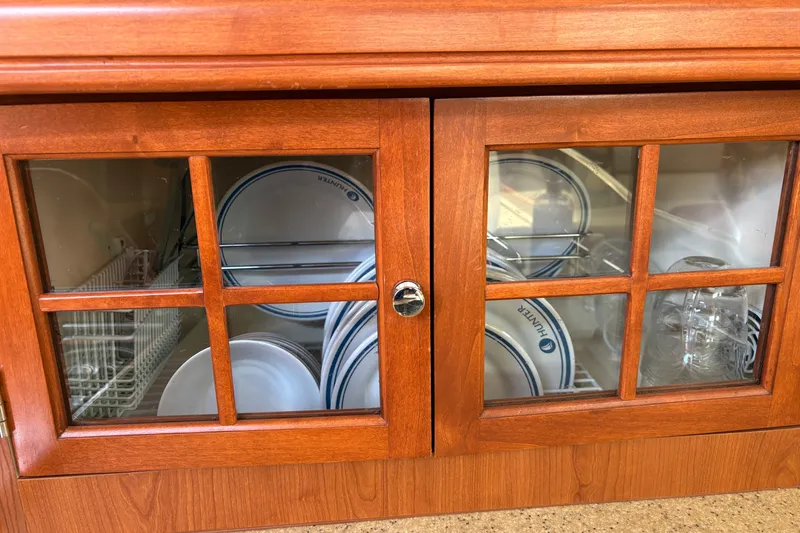 Slide: The Image of Wooden cabinet with glass doors displaying plates and glasses, Hunter 41 Deck Salon 2009. - 65
