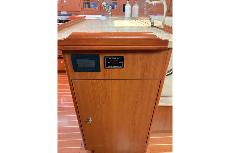 Slide: The Image of 2009 Hunter 41 Deck Salon interior with wood cabinetry and LPG control panel. - 66