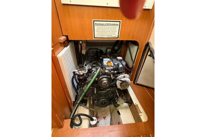 Slide: The Image of Engine compartment of a 2009 Hunter 41 Deck Salon sailboat, showcasing mechanical components. - 70