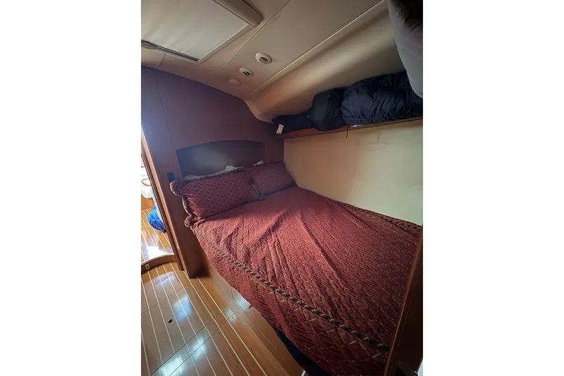 Slide: The Image of Cozy cabin interior of 2009 Hunter 41 Deck Salon with red bedding and wooden flooring. - 73