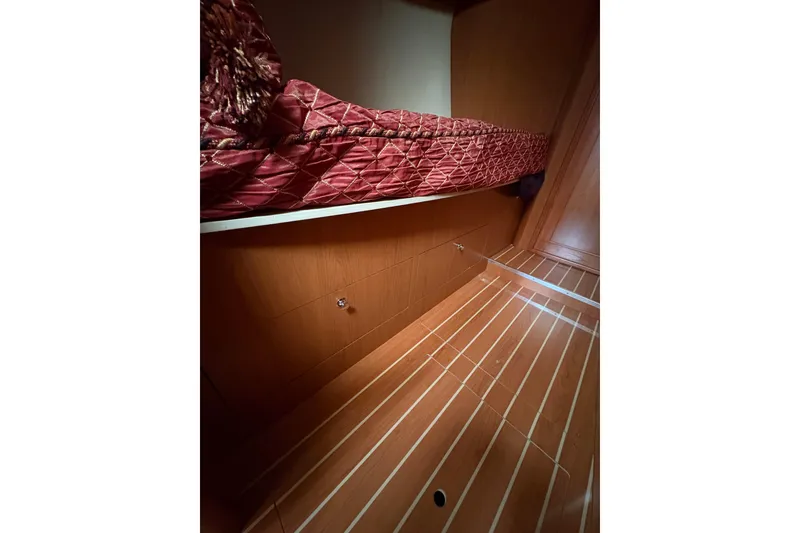 Slide: The Image of Interior of 2009 Hunter 41 Deck Salon with wooden flooring and red bedding. - 75