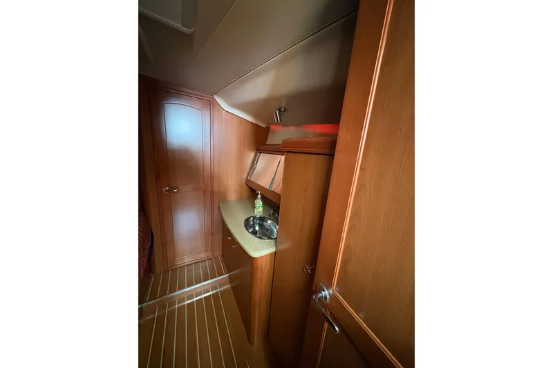 Slide: The Image of Interior of 2009 Hunter 41 Deck Salon yacht with wooden cabinetry and compact sink. - 76