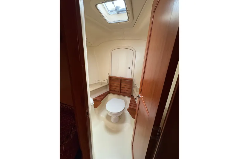 Slide: The Image of Interior view of 2009 Hunter 41 Deck Salon bathroom with skylight and wooden accents. - 78