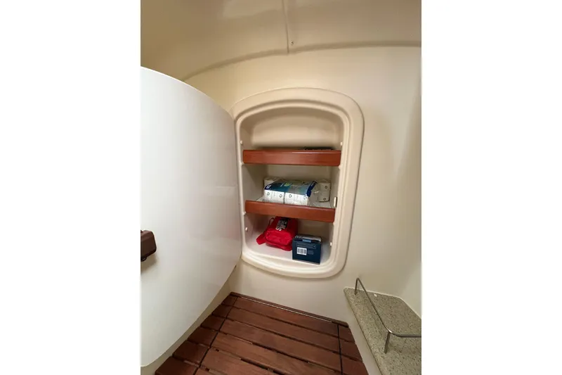 Slide: The Image of Storage shelves inside a 2009 Hunter 41 Deck Salon yacht, featuring wooden accents. - 79