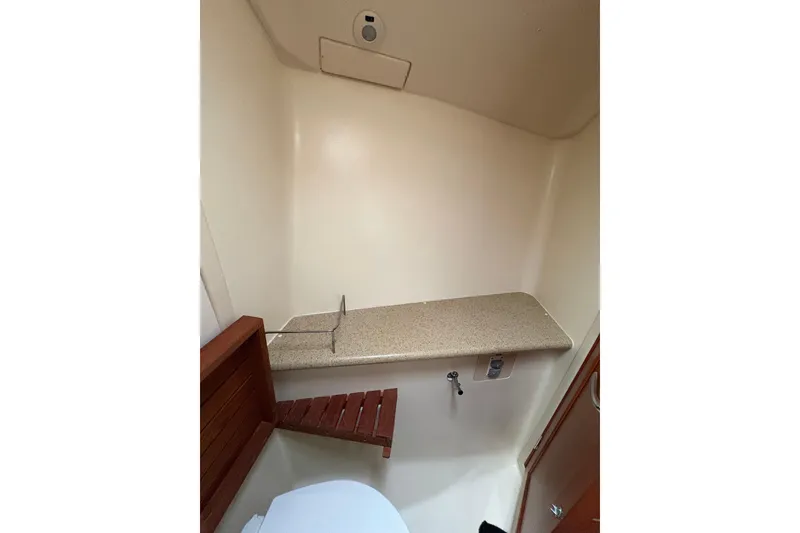 Slide: The Image of Interior of 2009 Hunter 41 Deck Salon bathroom with wooden accents and countertop. - 82